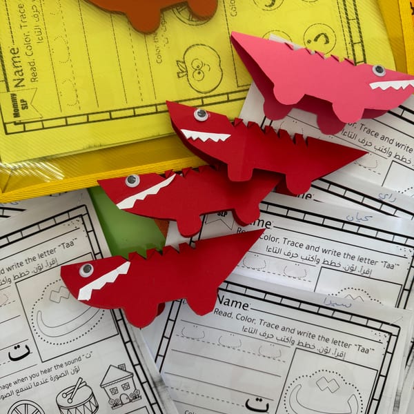 Colourful paper sharks on educational worksheets