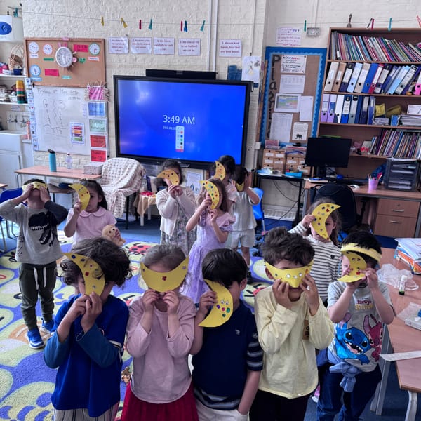 Children wearing Pokemon masks in classroom